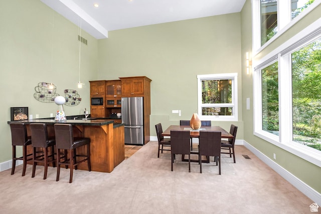 4127 E Mathews Way S, Salt Lake City, UT 84124 - dining area featuring visible vents, light carpet, a towering ceiling, and a healthy amount of sunlight