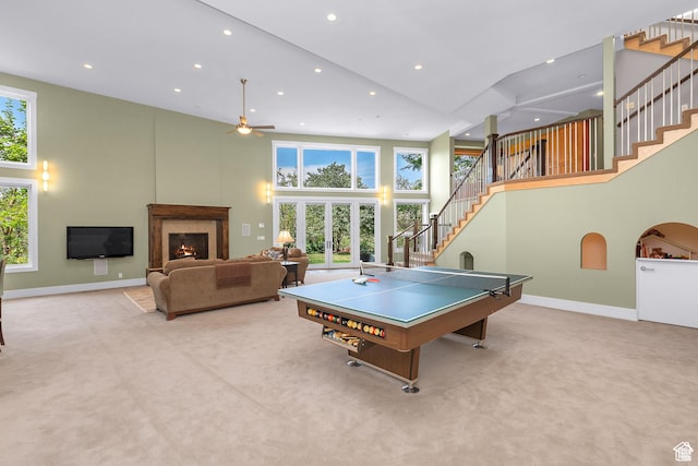 4127 E Mathews Way S, Salt Lake City, UT 84124 - playroom with a towering ceiling, a ceiling fan, baseboards, a lit fireplace, and carpet flooring