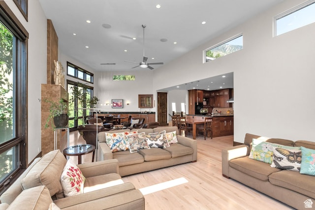 4127 E Mathews Way S, Salt Lake City, UT 84124 - living room with light wood-type flooring, a towering ceiling, recessed lighting, and ceiling fan