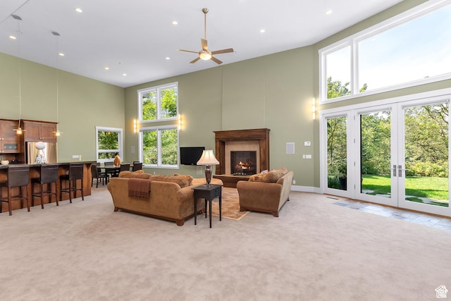 4127 E Mathews Way S, Salt Lake City, UT 84124 - living area featuring high vaulted ceiling, a warm lit fireplace, light colored carpet, and recessed lighting