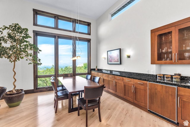 4127 E Mathews Way S, Salt Lake City, UT 84124 - dining room featuring light wood-style flooring and a towering ceiling