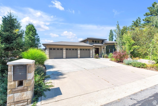 4127 E Mathews Way S, Salt Lake City, UT 84124 - prairie-style home with an attached garage, stone siding, and driveway