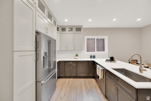 2745 E 3100 S, Millcreek, UT 84109 - kitchen featuring recessed lighting, light wood-style flooring, a peninsula, stainless steel appliances, and a sink