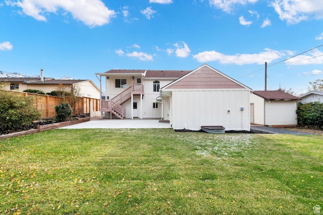 2745 E 3100 S, Millcreek, UT 84109 - rear view of house with a patio, a yard, fence, and board and batten siding