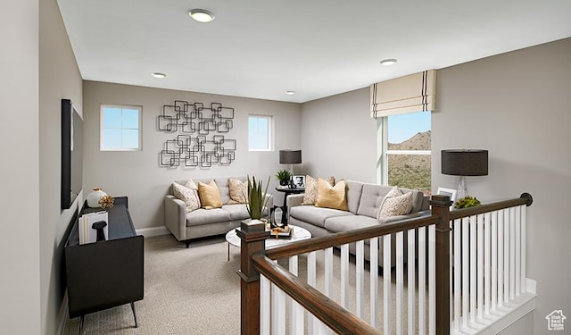 carpeted living room with baseboards