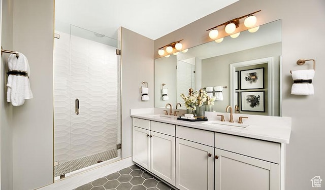 full bathroom featuring a shower stall, double vanity, and a sink