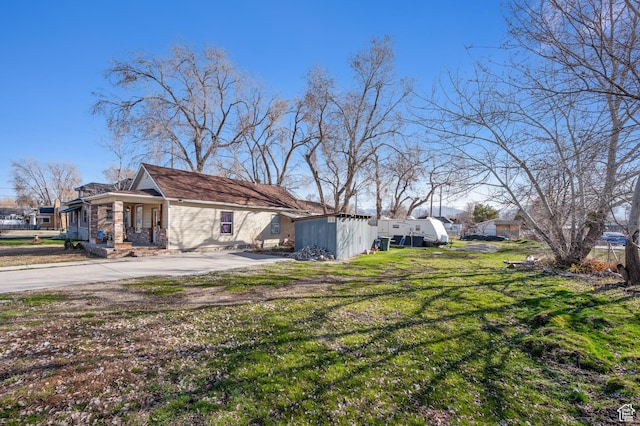 909 S Concord St, Salt Lake City, UT 84104 - view of home's exterior featuring an outbuilding and a lawn