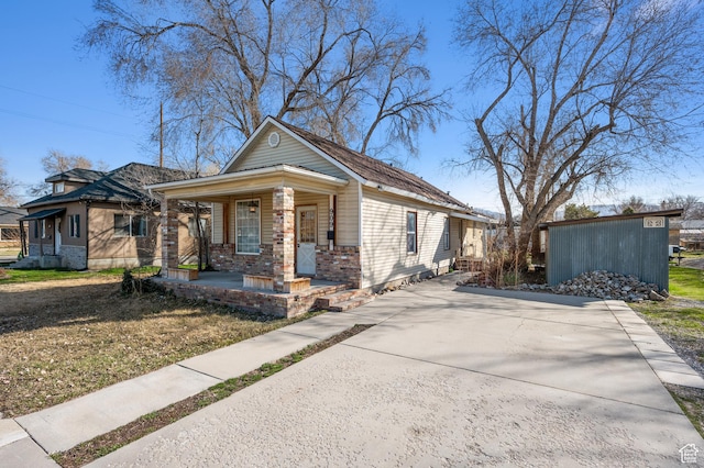 909 S Concord St, Salt Lake City, UT 84104 - view of front of property with brick siding and a porch
