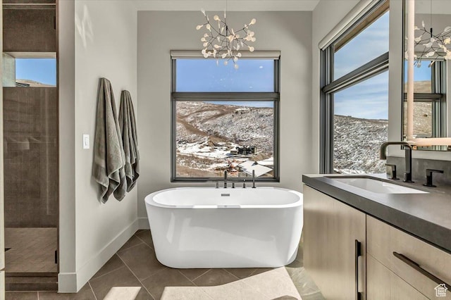 11503 N Soaring Hawk Ln, Hideout, UT 84036 - bathroom with a freestanding bath, a chandelier, tile patterned floors, vanity, and tiled shower