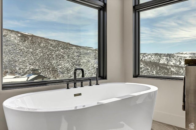11503 N Soaring Hawk Ln, Hideout, UT 84036 - full bath featuring a mountain view, a soaking tub, and tile patterned flooring