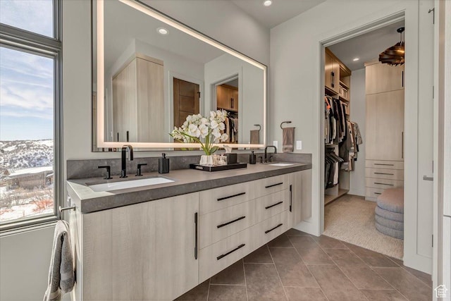 11503 N Soaring Hawk Ln, Hideout, UT 84036 - bathroom featuring plenty of natural light, double vanity, a walk in closet, recessed lighting, and tile patterned flooring