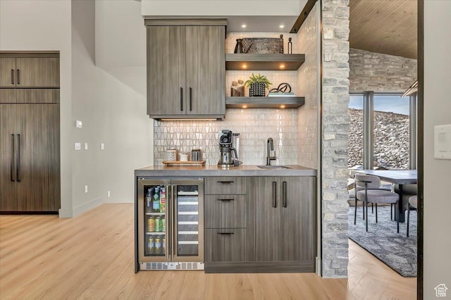 11503 N Soaring Hawk Ln, Hideout, UT 84036 - indoor wet bar with wine cooler, vaulted ceiling, decorative backsplash, and light wood-style floors