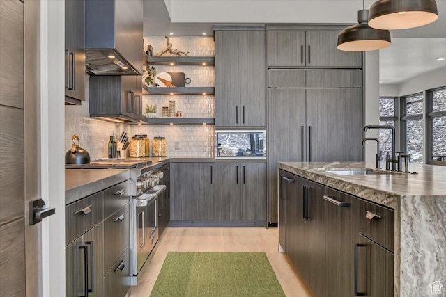 11503 N Soaring Hawk Ln, Hideout, UT 84036 - kitchen with wall chimney range hood, high end stainless steel range, decorative backsplash, and decorative light fixtures