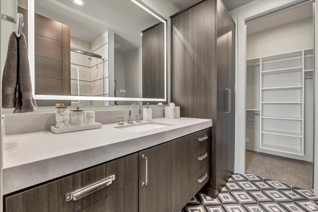 11503 N Soaring Hawk Ln, Hideout, UT 84036 - bathroom featuring vanity, a tile shower, a walk in closet, and tile patterned floors