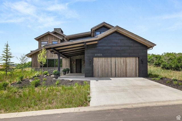 11503 N Soaring Hawk Ln, Hideout, UT 84036 - view of front of property featuring a chimney, an attached garage, concrete driveway, and stone siding