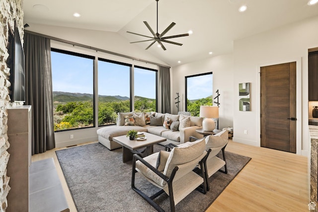 11503 N Soaring Hawk Ln, Hideout, UT 84036 - living room with light wood-style flooring, vaulted ceiling, a ceiling fan, recessed lighting, and a mountain view