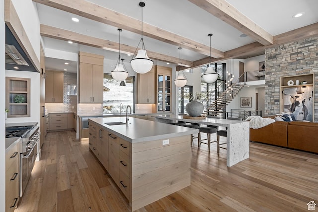 6421 E Evening Star Dr, Kamas, UT 84036 - kitchen with modern cabinets, light brown cabinets, a large island with sink, and a sink