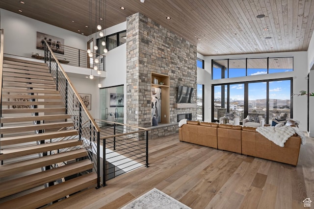6421 E Evening Star Dr, Kamas, UT 84036 - living room featuring a stone fireplace, wooden ceiling, and hardwood / wood-style floors