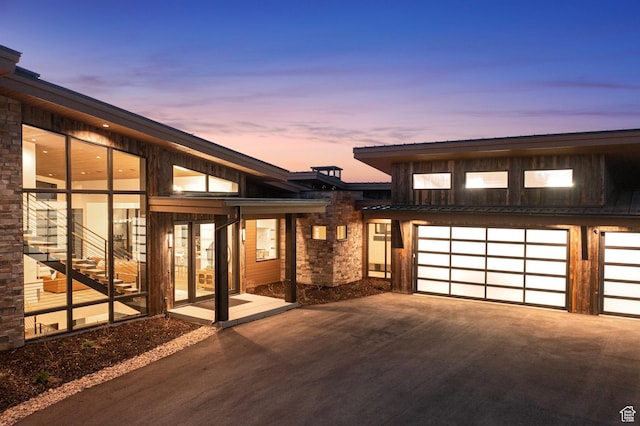 6421 E Evening Star Dr, Kamas, UT 84036 - back of house featuring stone siding, concrete driveway, and a garage