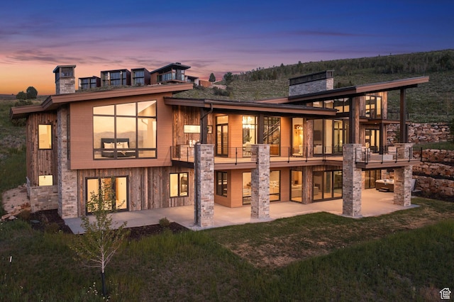 6421 E Evening Star Dr, Kamas, UT 84036 - back of house with a patio area, a lawn, a chimney, and a balcony