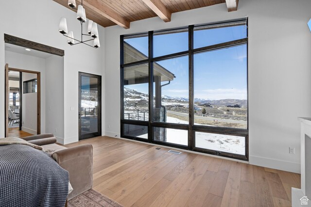 6421 E Evening Star Dr, Kamas, UT 84036 - interior space with beam ceiling, access to exterior, light wood-style floors, wooden ceiling, and a notable chandelier