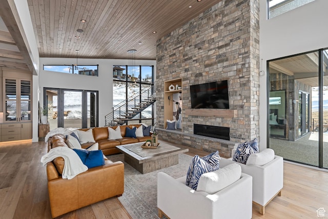 6421 E Evening Star Dr, Kamas, UT 84036 - living room with a stone fireplace, wood ceiling, a towering ceiling, and wood finished floors