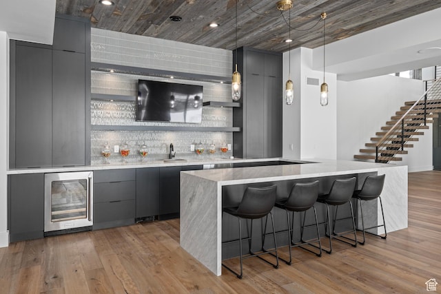6421 E Evening Star Dr, Kamas, UT 84036 - bar featuring indoor wet bar, wine cooler, backsplash, and light wood finished floors