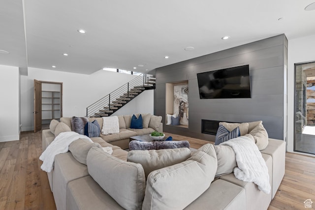 6421 E Evening Star Dr, Kamas, UT 84036 - living room with light wood-type flooring, recessed lighting, stairway, a fireplace, and baseboards