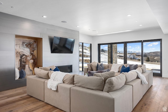 6421 E Evening Star Dr, Kamas, UT 84036 - living room with a large fireplace, recessed lighting, and light wood-type flooring