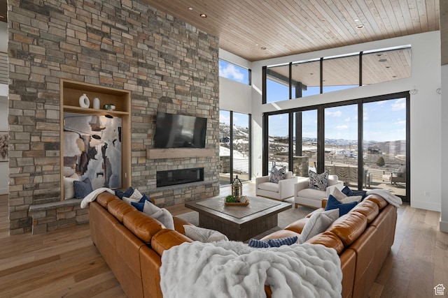 6421 E Evening Star Dr, Kamas, UT 84036 - living room with a towering ceiling, wood ceiling, hardwood / wood-style floors, and a fireplace