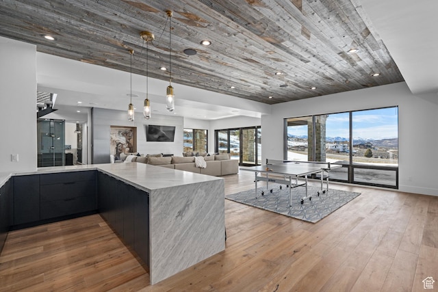 6421 E Evening Star Dr, Kamas, UT 84036 - kitchen with light wood finished floors, hanging light fixtures, light countertops, modern cabinets, and open floor plan