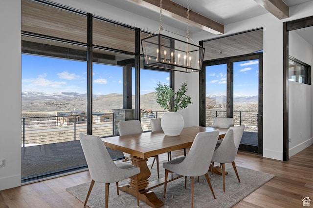 6421 E Evening Star Dr, Kamas, UT 84036 - dining area featuring a chandelier, plenty of natural light, a mountain view, and light wood-style floors