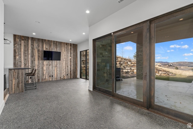 6421 E Evening Star Dr, Kamas, UT 84036 - unfurnished living room featuring wooden walls, recessed lighting, and visible vents