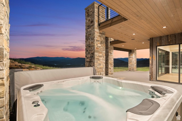 6421 E Evening Star Dr, Kamas, UT 84036 - pool at dusk featuring a mountain view and a hot tub