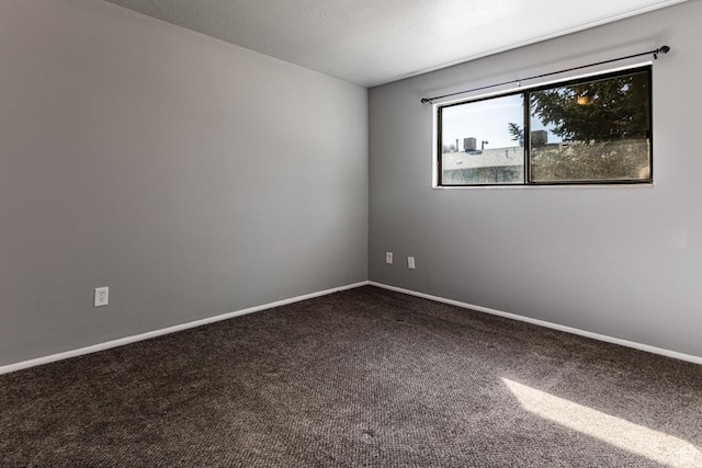 1325 S Lincoln Ave Unit 19, Ogden, UT 84404 - spare room with dark colored carpet and baseboards