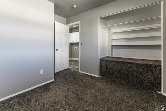 1325 S Lincoln Ave Unit 19, Ogden, UT 84404 - interior space featuring a textured ceiling, baseboards, and dark colored carpet