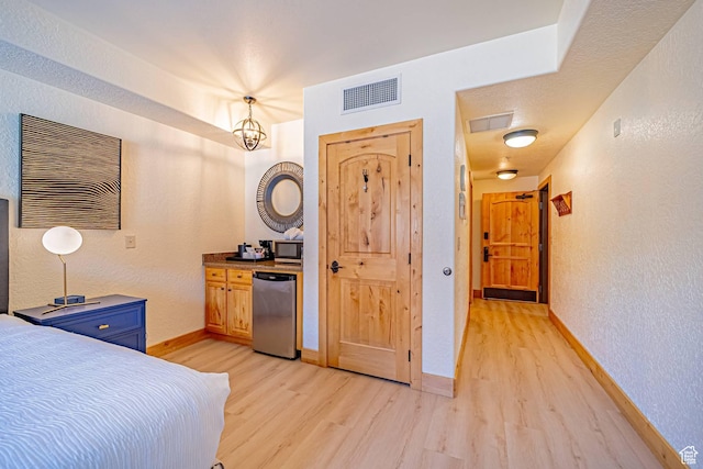 2669 Canyons Resort Dr Unit 314, Park City, UT 84098 - bedroom featuring light wood-type flooring, baseboards, visible vents, and a textured wall