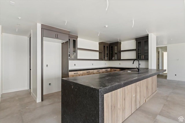 1878 E Chimney Rock Rd S Unit 536, Heber City, UT 84032 - kitchen featuring a sink, concrete flooring, glass insert cabinets, open shelves, and a large island