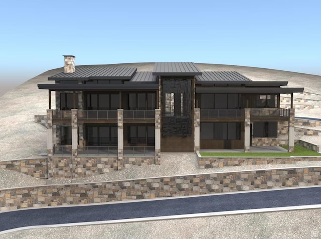 1878 E Chimney Rock Rd S Unit 536, Heber City, UT 84032 - back of property featuring a balcony, a standing seam roof, metal roof, stone siding, and a chimney