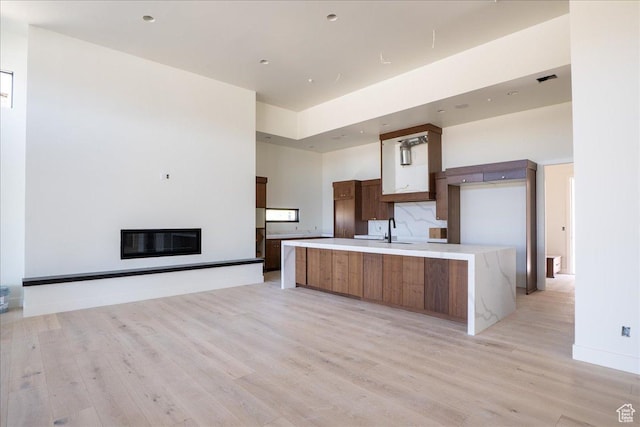 1878 E Chimney Rock Rd S Unit 536, Heber City, UT 84032 - kitchen with light wood finished floors, modern cabinets, a sink, light countertops, and a large island