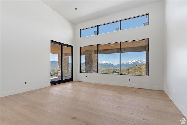 1878 E Chimney Rock Rd S Unit 536, Heber City, UT 84032 - empty room with light wood finished floors, a towering ceiling, and baseboards