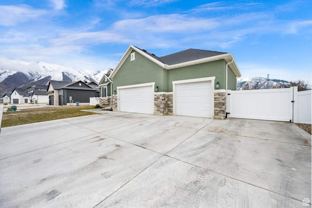 2998 E 80 S, Spanish Fork, UT 84660 - view of home's exterior featuring stucco siding, an attached garage, driveway, a gate, and a mountain view