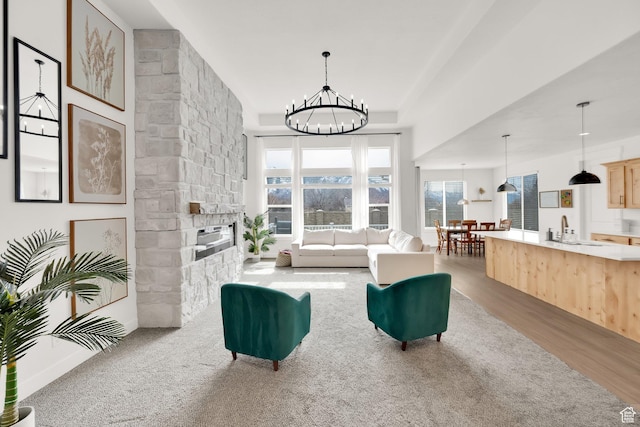 2998 E 80 S, Spanish Fork, UT 84660 - living room with an inviting chandelier, a stone fireplace, and light wood-style floors