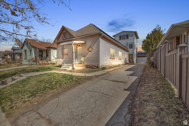 view of front of property with fence and brick siding