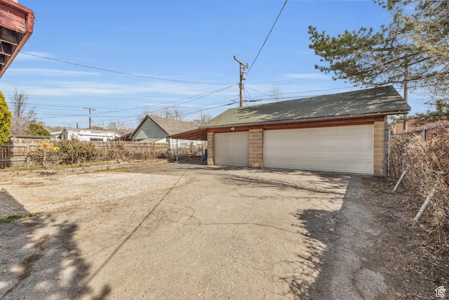 detached garage featuring fence