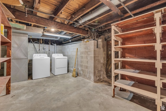 unfinished basement featuring washing machine and dryer