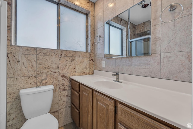 full bathroom featuring an enclosed shower, toilet, tile walls, and vanity