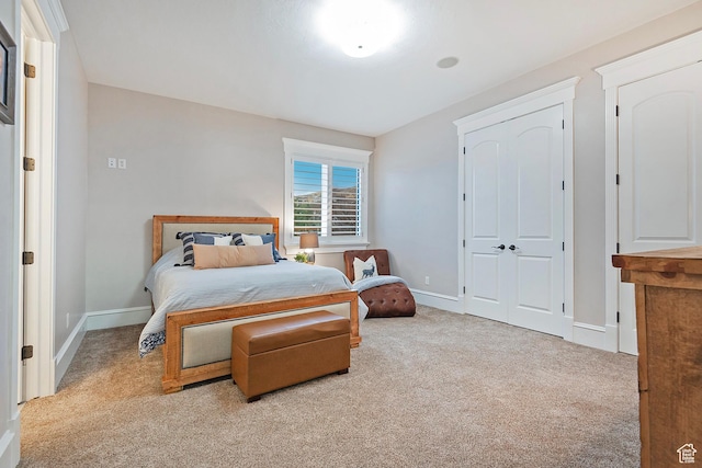 carpeted bedroom featuring baseboards