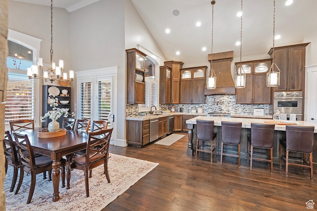 dining area with high vaulted ceiling, a chandelier, dark wood-style flooring, and recessed lighting