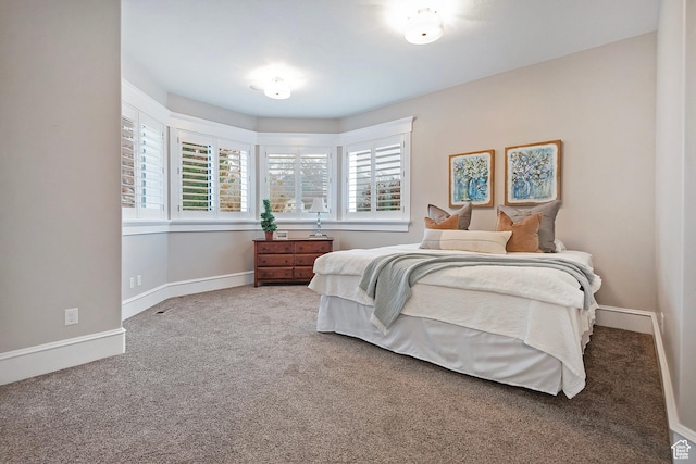 carpeted bedroom featuring baseboards